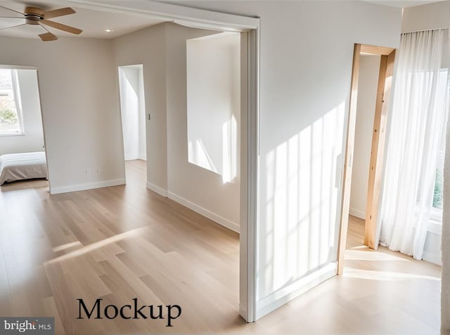 empty room with light wood-type flooring and ceiling fan