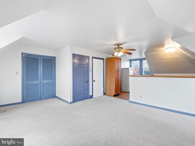 bonus room with ceiling fan, lofted ceiling, and light carpet