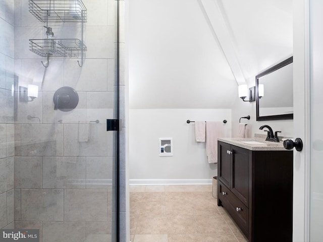 bathroom with vanity, a shower with shower door, and vaulted ceiling