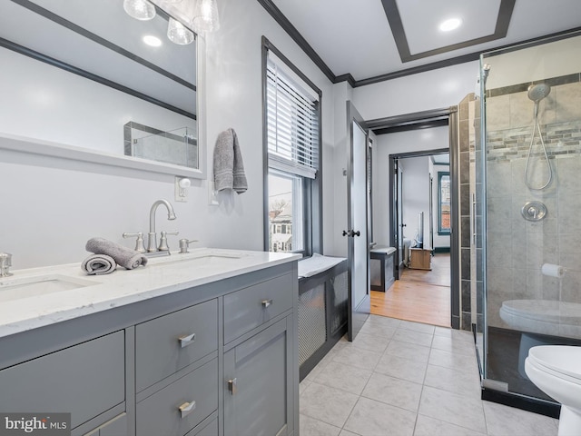 bathroom featuring vanity, tile patterned floors, crown molding, toilet, and a shower with shower door