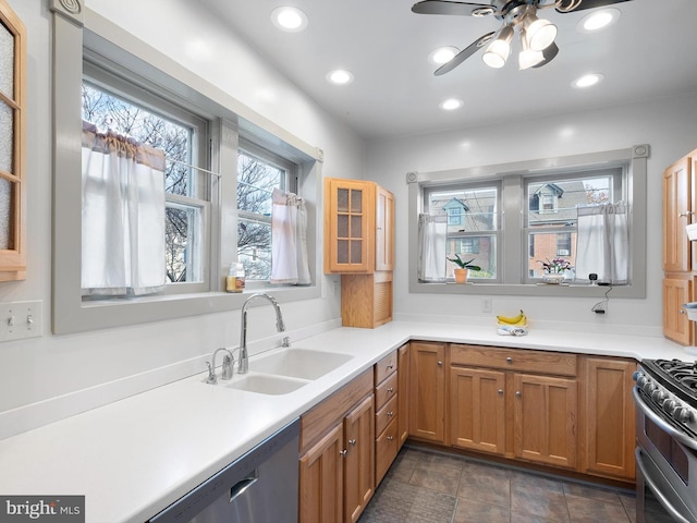 kitchen with ceiling fan, sink, and stainless steel appliances