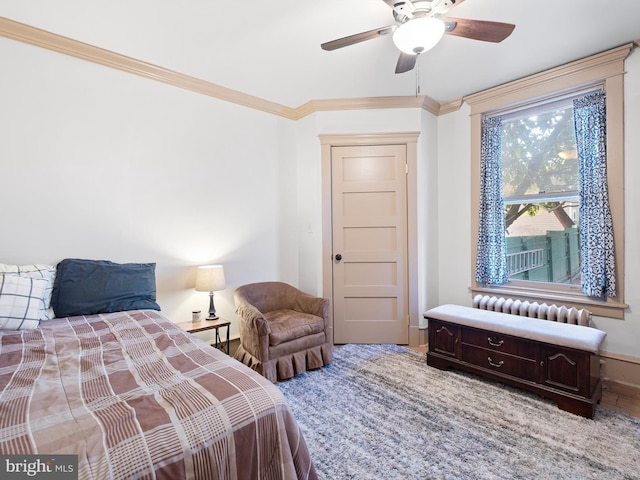 bedroom featuring ceiling fan and crown molding