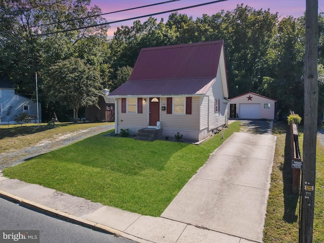 bungalow-style house with an outbuilding, a garage, and a lawn