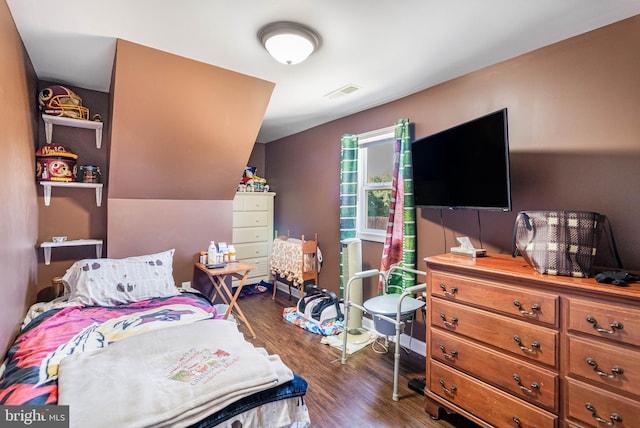 bedroom with dark wood-type flooring