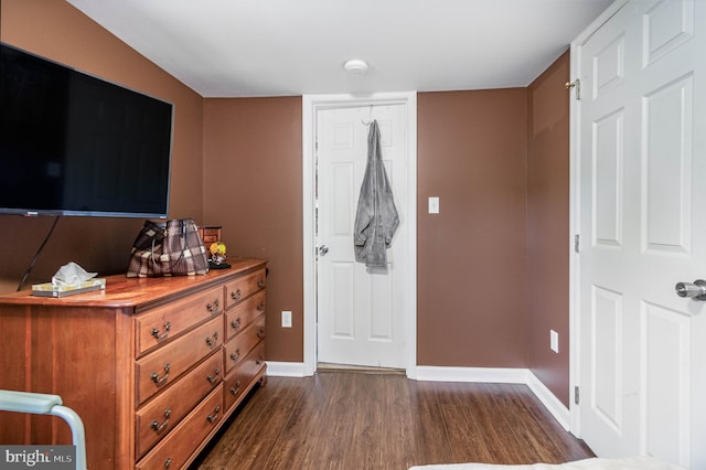 bedroom featuring dark hardwood / wood-style floors and a closet