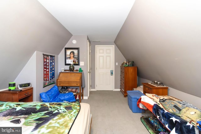 carpeted bedroom featuring lofted ceiling