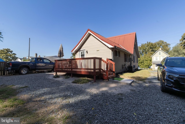 view of front of house with central AC and a deck