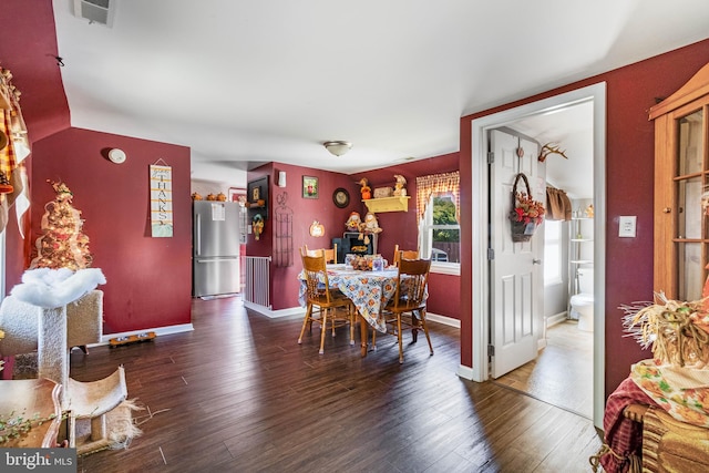 dining space with dark wood-type flooring