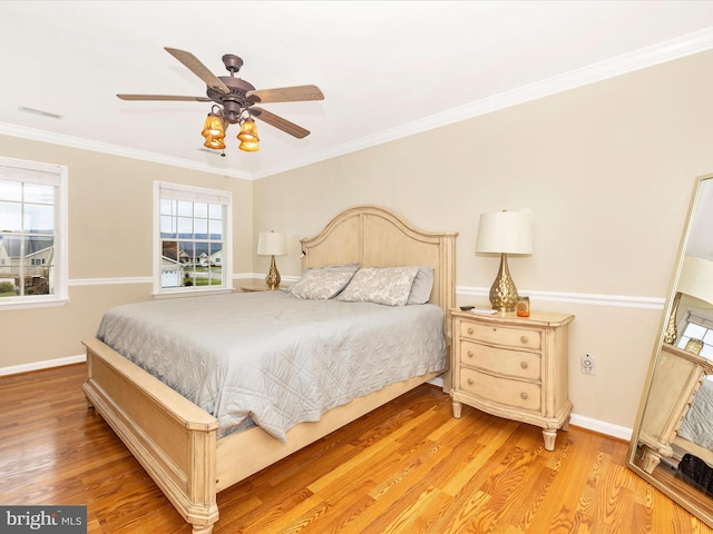 bedroom with crown molding, ceiling fan, and light hardwood / wood-style flooring