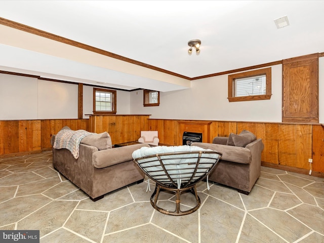 living room featuring ornamental molding and wood walls