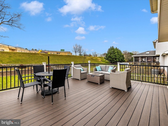 wooden terrace featuring a yard and outdoor lounge area