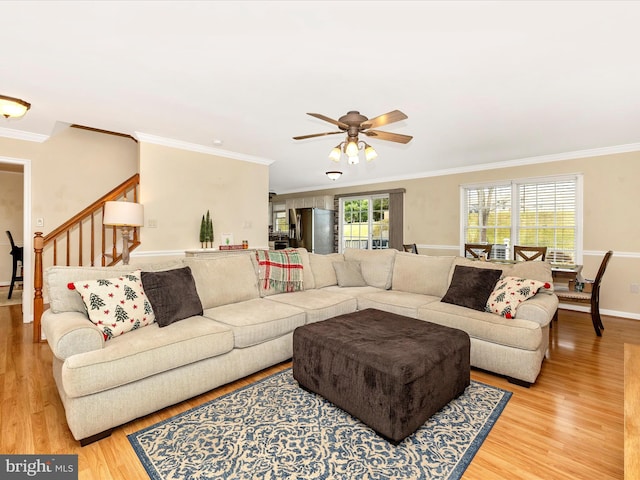 living room featuring crown molding, ceiling fan, and hardwood / wood-style flooring