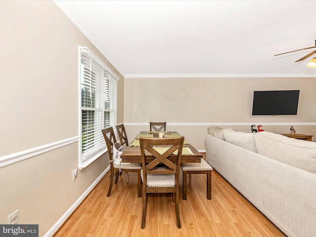 dining room with hardwood / wood-style flooring, ceiling fan, and ornamental molding