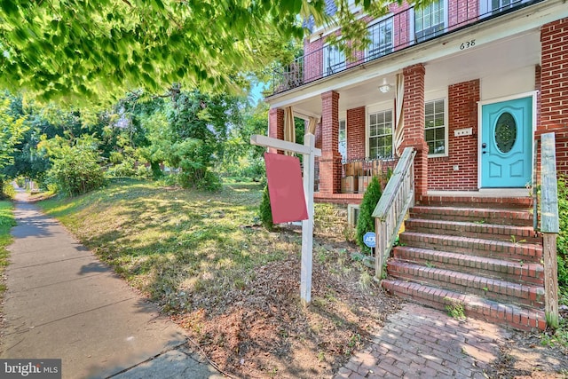 doorway to property featuring covered porch