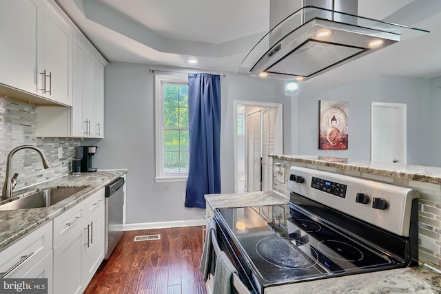 kitchen featuring light stone countertops, appliances with stainless steel finishes, tasteful backsplash, sink, and white cabinets