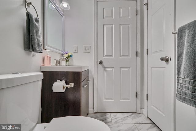 bathroom with toilet and vanity