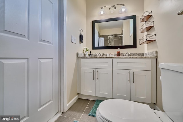 bathroom featuring vanity, toilet, and a shower with curtain