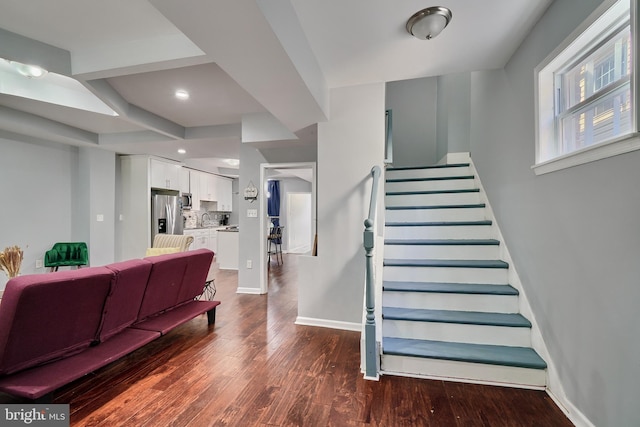 staircase with sink and hardwood / wood-style floors