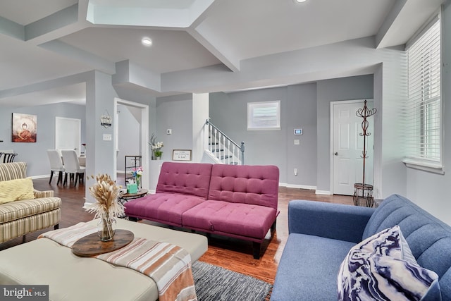 living room with hardwood / wood-style floors and beam ceiling