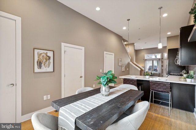 dining space with light hardwood / wood-style floors