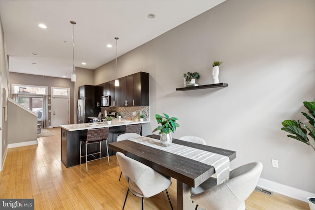 dining area with light hardwood / wood-style flooring