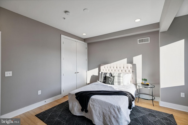 bedroom with a closet and light hardwood / wood-style flooring