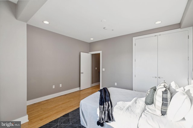 bedroom featuring wood-type flooring and a closet