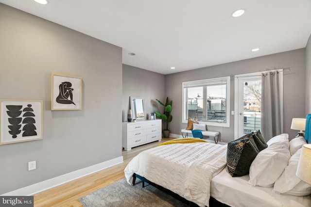 bedroom featuring light wood-type flooring and access to outside