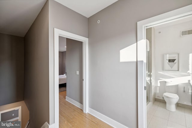 bathroom with toilet and hardwood / wood-style flooring