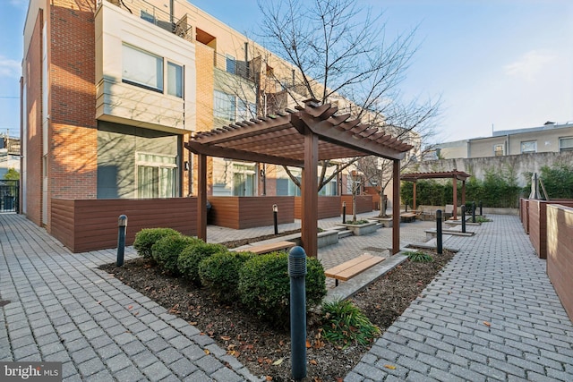 view of home's community featuring a pergola and a patio