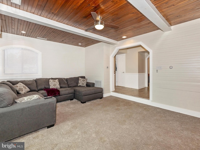 living room with beamed ceiling, ceiling fan, wooden ceiling, and carpet floors