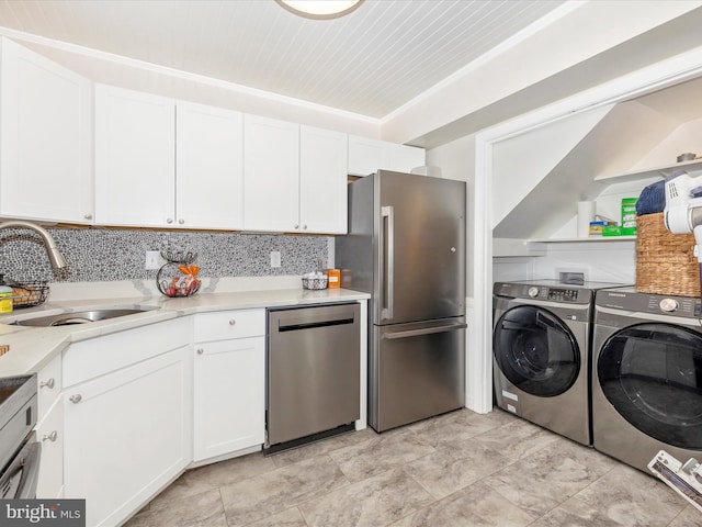 kitchen featuring white cabinetry, independent washer and dryer, sink, and appliances with stainless steel finishes