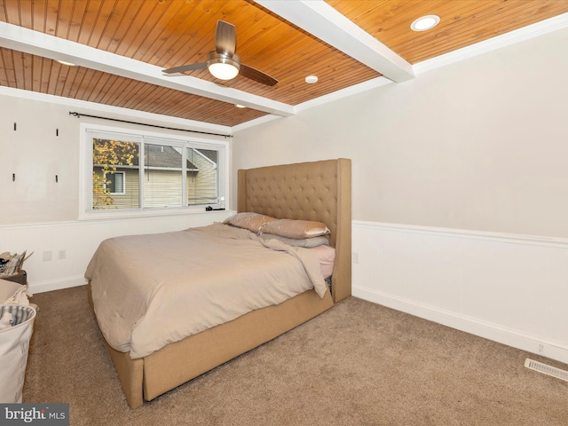 bedroom with carpet flooring, wood ceiling, ceiling fan, crown molding, and beam ceiling