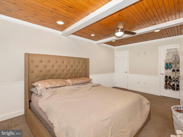 bedroom with carpet flooring, beam ceiling, ceiling fan, wooden ceiling, and crown molding