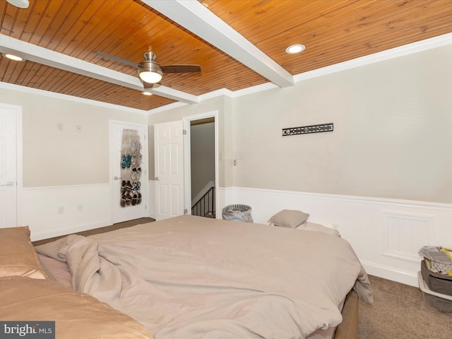 carpeted bedroom featuring ornamental molding, ceiling fan, wooden ceiling, and beam ceiling