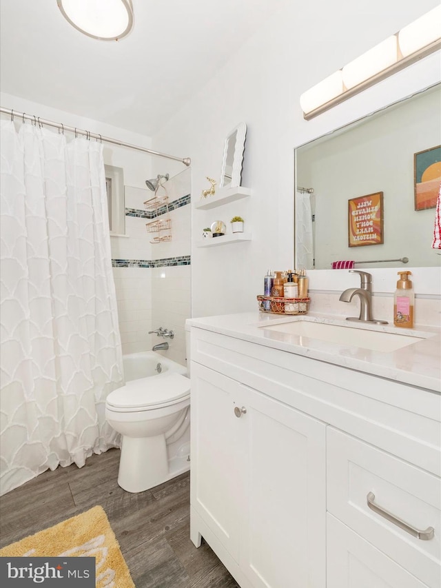 full bathroom featuring vanity, hardwood / wood-style flooring, toilet, and shower / bath combo with shower curtain