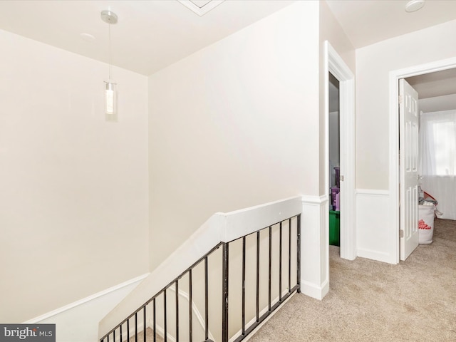 hallway featuring light carpet