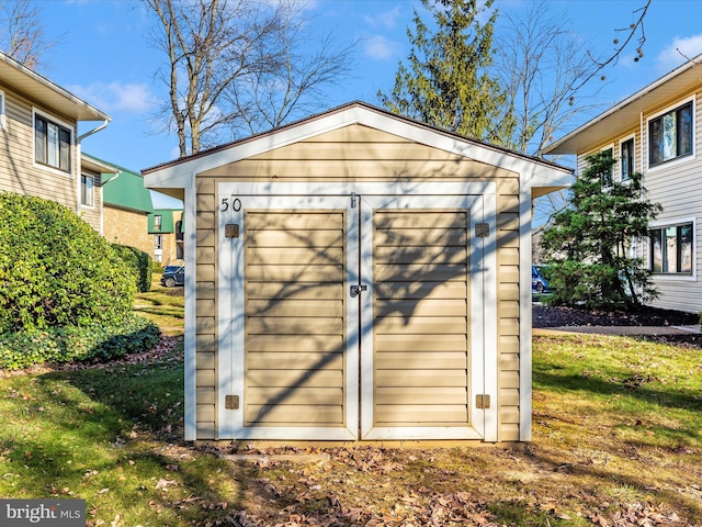 view of outbuilding featuring a yard