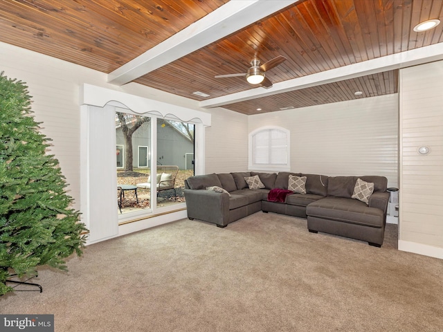 carpeted living room with beamed ceiling, ceiling fan, and wooden ceiling