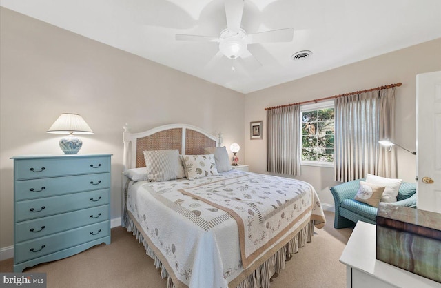 bedroom with ceiling fan and light carpet