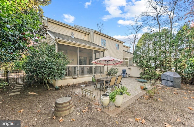 rear view of house with a patio area and a sunroom