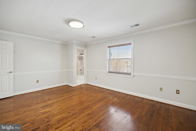 spare room featuring hardwood / wood-style floors and crown molding