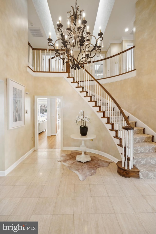 stairs featuring tile patterned floors and a towering ceiling