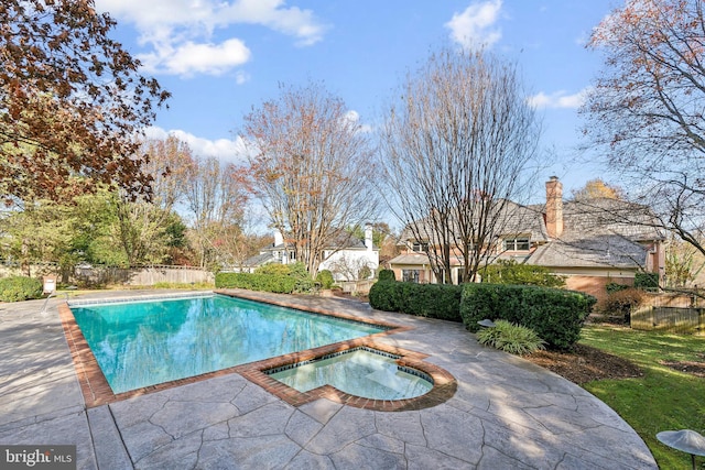 view of pool featuring a patio area and an in ground hot tub