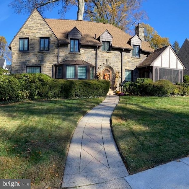 tudor home with a front yard