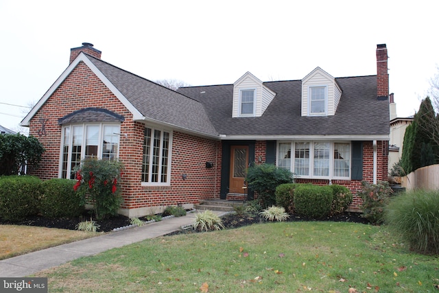 new england style home with a front lawn