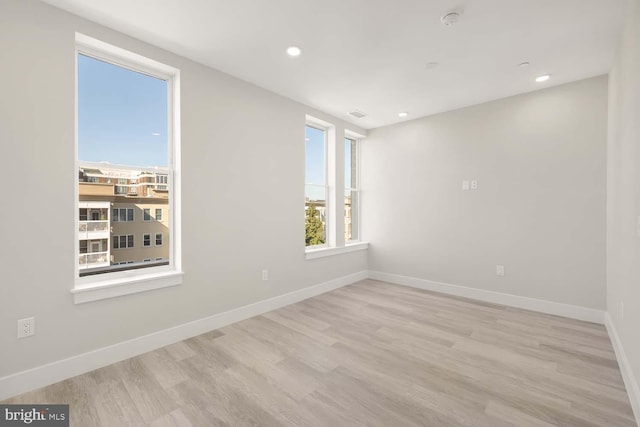 unfurnished room featuring light hardwood / wood-style floors