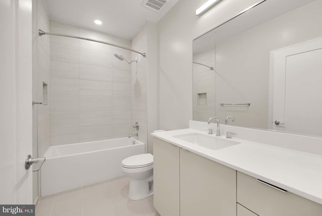 full bathroom featuring tile patterned floors, vanity, toilet, and tiled shower / bath