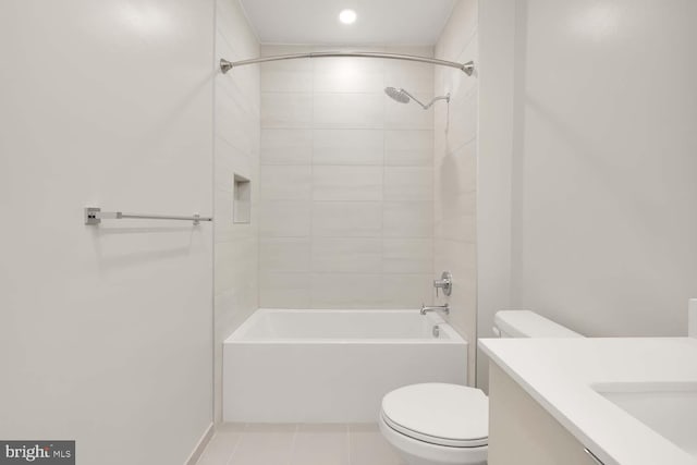 full bathroom featuring tile patterned floors, vanity, toilet, and tiled shower / bath