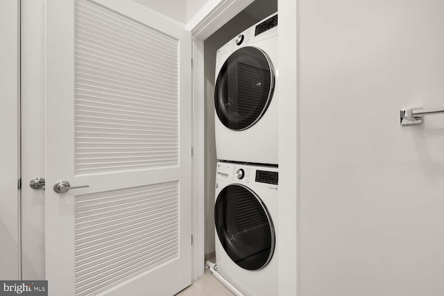 washroom with stacked washer / drying machine